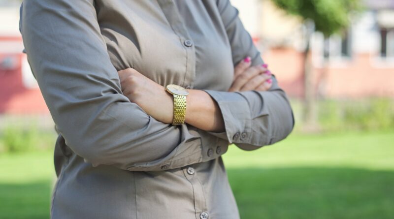 Close up of folded arms of business woman